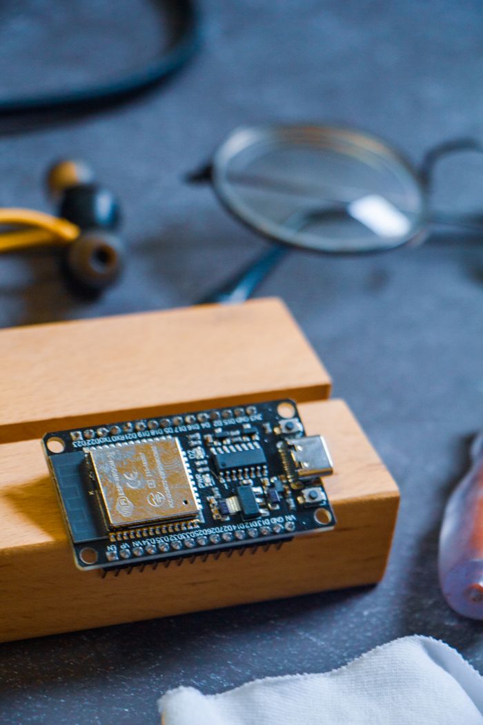 Crafting Captivating Headlines: Your awesome post title goes here Close-up of a microcontroller on a wooden block, showcasing modern technology in Dhaka, Bangladesh.
